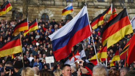 Supporters-of-the-anti-Islam-movement-PEGIDA-carry-German-and-Russian-flags-duri